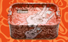 Airtight Stash Box & Tray in a rectangular red design with handles, decorated with a white illustrated hand displaying an eye in the palm and swirling orange patterns. “CAMO” is printed on the inside, and the background mirrors the orange-toned swirling motif.